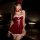 A woman wearing a festive red velvet dress with white fur trim, featuring lace-up details and bunny ears, perfect for new yea...