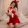A woman wears a festive red velvet christmas sleep dress with white accents, holding a candle, perfect for new year parties o...