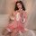 A woman wearing a pink xintao christmas lingerie set, featuring a red velvet sleep dress with ruffles and heart details, perf...