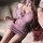 A woman poses in a sheer pink xishi sexy kimono sleep dress, featuring delicate floral accents and a halter neck design, perf...