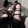 Edgy black ripped thigh-high socks with lace-up leg warmers, perfect for bold fashion statements.