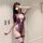 Woman wearing purple yan yan flirty lingerie set with open-crotch bodysuit, lace detailing, and thigh garters.