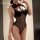 Woman wearing black yaqin nu lace open-crotch nightgown with hook-neck design, perfect for sensual bedroom wear and date nigh...