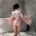 A woman stands by a bathtub wearing a pink yasise night fantasy lingerie set, featuring a deep v cut and floral patterns remi...