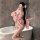 A woman poses in a bathroom wearing a pink yasise kimono-style sleepwear set, featuring floral patterns and a flowing design,...