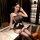 Elegant black lace bodysuit with pearl embellishments, backless design, and lace-trimmed stockings, perfect for women seeking...