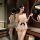 Elegant white pearl-embellished backless bodysuit with lace detailing and black bow accent, perfect for women seeking stylish...