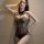 Woman wearing ye qing ge sexy transparent bodysuit with mesh detailing and halter neck, alluring lingerie one-piece.