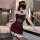 A woman poses in a stylish black and red lingerie skirt, featuring sheer details and rose embellishments, paired with stockin...