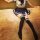 A person wearing a sailor-style school uniform with thigh-high stockings, sitting on a carpeted floor. the outfit features a ...