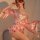 A woman poses elegantly in a luxurious pink satin yelanqu plus size lingerie set, featuring a deep v neckline and flowing kim...