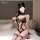 Woman wearing yeqin black lace bodysuit with cat ears, sheer mesh stockings, and choker on bed.