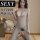 Woman modeling yeqingge sexy lace bodysuit with sheer mesh, open-crotch fishnet stockings and all-in-one lingerie design.