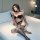 Woman wearing yeqingge sexy lace open-crotch bodystocking with sheer mesh stockings, posing on a bed in intimate setting.