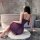 Woman in purple yese yese sensual lingerie dress – sheer mesh bodycon corset slip with adjustable straps, seated on rug near ...