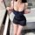 Woman wearing navy blue yese yese sensual lingerie dress with sheer mesh, lace corset top, and ruffled hem in bathroom.