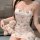 A woman wears a cute, printed cami dress featuring adorable cat faces and bows. she holds a small teddy bear dressed in white...