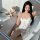 A woman lounges in a bathtub wearing a white cami dress adorned with playful cat prints. the dress features a built-in padded...
