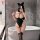 Woman in black yesiyesi sexy lace bodysuit with halter neck, cat ears, and thigh-high stockings posing by bathtub.