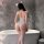 Woman wearing yesiyesi sexy lace bodysuit with halter neck, posing by bathtub in elegant nightwear.