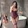 Woman in bathroom wearing purple yeyu plus size lace lingerie set with underwire, padded cups & garter straps.