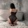Woman wearing yeyu plus size lace lingerie set with underwire and padded cups, kneeling in bathroom.