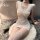 A woman wearing a revealing white lace qipao dress with open bust design, featuring a pencil skirt and thigh-high stockings, ...