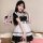 A woman models the yimenglan maid costume dress, featuring a black and white design with ruffles and a bow tie, perfect for c...