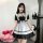 A woman models the yimenglan maid costume dress, featuring a black and white design with ruffles and a corset-style front. pe...