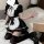 A woman poses wearing a black and white maid-style sleepwear set from yimenglan, featuring ruffles, bows, and thigh-high stoc...