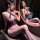 Woman modeling purple yingqing bodysuit with sheer mesh stockings in front of mirror.