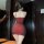 A woman stands facing away from the camera, wearing a form-fitting red sheer mesh sleep dress with padded straps. the design ...