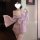 A woman wears a delicate pink yiyue original kawaii bunny kimono lingerie set, featuring floral patterns and lace details, pe...