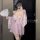 A woman poses in a pink yiyue original kawaii bunny kimono lingerie set, featuring delicate lace details and playful bunny mo...