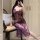 A woman poses in a sheer high-slit sleepwear, featuring purple lace and underwire push-up support, ideal for women seeking el...
