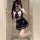 A person wearing a schoolgirl uniform set, featuring a sailor-style top with a blue bow tie and pleated skirt, paired with th...