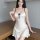 Elegant white satin slip dress featuring black polka dots, delicate lace trim, and a charming bow detail for romantic intimat...