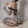 Woman wearing yue die sexy lace bodysuit & sheer mesh stockings set, featuring black lace trim and ruffled skirt, posed on wh...