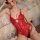 Woman wearing red yue die lace bodysuit with open-crotch design, sheer temptation outfit for seductive sleepwear or costume.