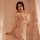 Woman wearing yue die sexy lace sleepwear set with cut-out cami and matching robe, posing in soft lighting.