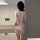 Woman wearing yuedie sparkly sequin sleep dress with deep v back, showcasing alluring lingerie design for nightwear.
