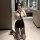 A woman poses in a bathroom wearing a yujie-style secretary sexy pure-yu summer shirt set, featuring a slim-fit design with a...