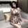 A woman sits on a couch wearing an elegant ancient chinese style sheer lace erotic sleepwear set, featuring intricate embroid...