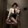 A woman poses in a zimei sexy nightwear set, featuring a white blouse with a black tie, paired with a black mini skirt and sh...