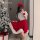 A woman poses with a christmas tree, wearing a festive red and white santa outfit from ziqu new years collection, perfect for...