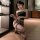 Woman in black bustier and leopard print bodysuit, feimu secretary sexy lingerie set zy74, kneeling pose.