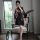A woman poses elegantly in a black japanese anime-inspired sheer kimono-style sleepwear set, featuring floral patterns and cu...