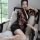 A woman poses elegantly in a black japanese anime-themed sheer kimono-inspired sleepwear set, featuring vibrant floral patter...
