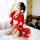 A woman sits on a bed wearing a red japanese-style lace robe with floral patterns, featuring a deep v-neckline and long kimon...